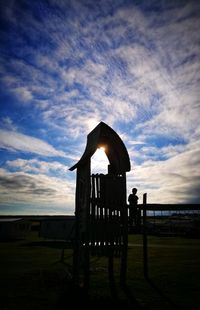Built structure on field against sky