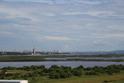 Scenic view of sea and buildings against sky