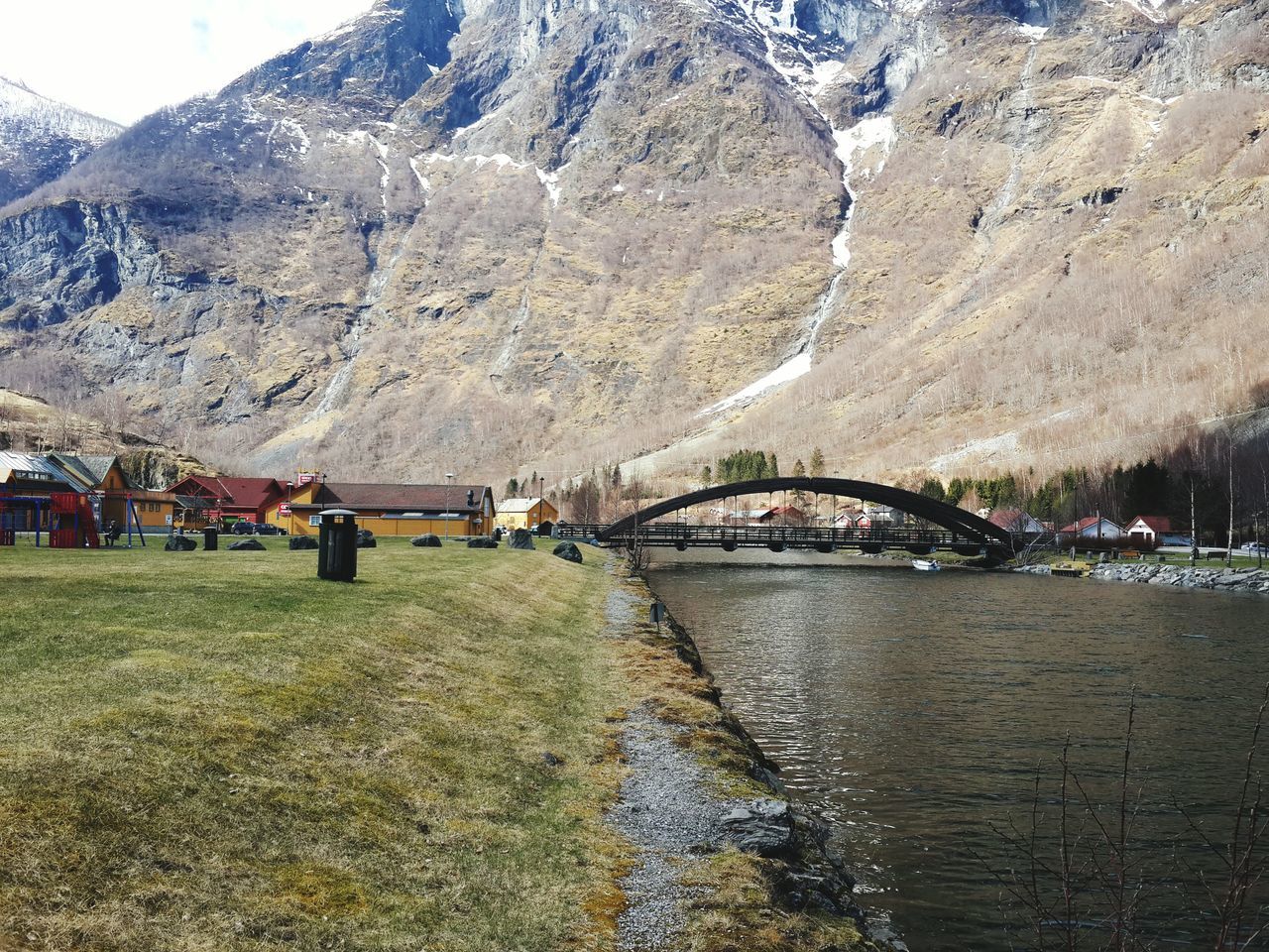 mountain, built structure, architecture, transportation, bridge - man made structure, season, winter, connection, snow, cold temperature, scenics, tranquil scene, mode of transport, nature, travel destinations, tranquility, non-urban scene, water, beauty in nature, day, outdoors, rock formation, tourism, mountain range, rocky mountains, physical geography, vacations, sky