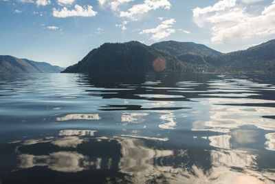 Scenic view of lake and mountains against sky