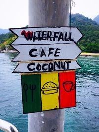 Close-up of text on lake against sky