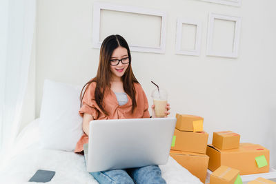 Young woman using mobile phone at home