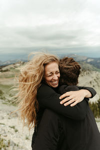 Over the moon female hugs her fiance after a surprise proposal