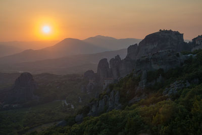 Beautiful view of meteora mountains and monasteries in a summerday at sunset