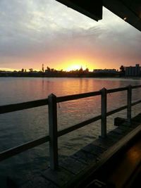 Pier on sea at sunset