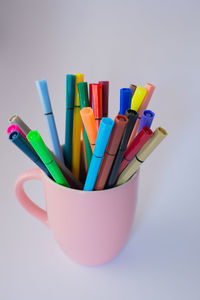 Close-up of colored pencils against white background