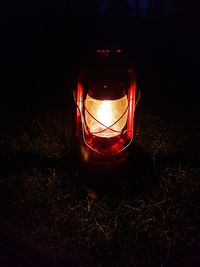 Close-up of illuminated lantern on field