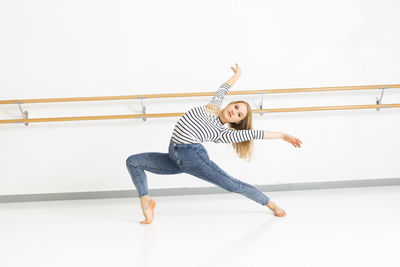 Young woman with exercising at ballet studio