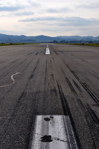 Airplane on road against sky