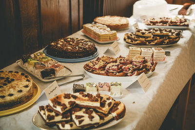 High angle view of various sweet food arranged on table in buffet