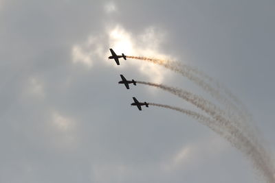 Low angle view of airshow against sky