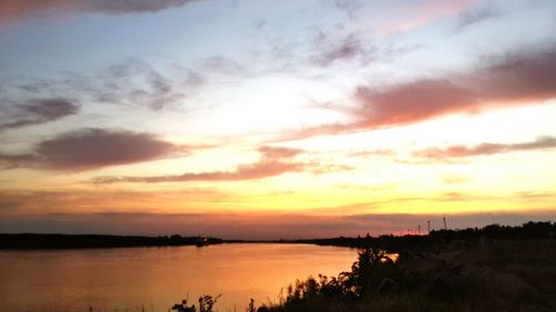 Scenic view of lake against romantic sky at sunset