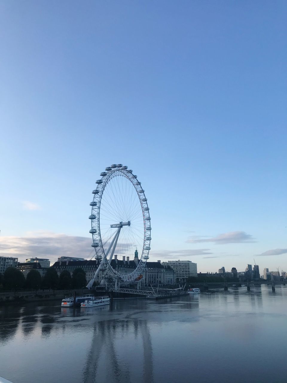 ferris wheel, sky, amusement park, amusement park ride, water, arts culture and entertainment, architecture, built structure, waterfront, nature, river, copy space, no people, building exterior, reflection, travel destinations, transportation, day, outdoors