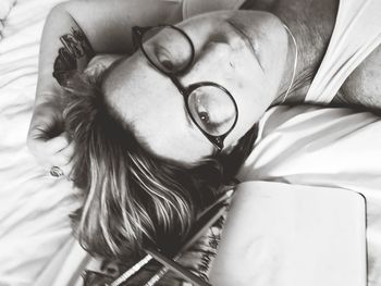 Close-up portrait of woman lying on bed at home