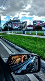 Reflection of man in car mirror