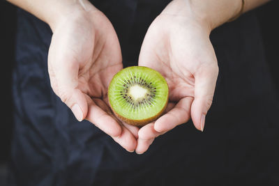 Midsection of person holding apple