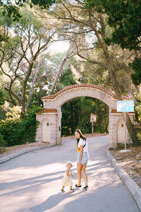 Rear view of woman walking on road