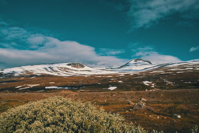 Scenic view of snowcapped mountains against sky