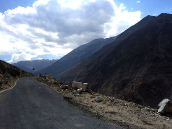 Road amidst mountains against sky