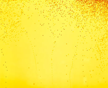 Full frame shot of water drops on yellow background