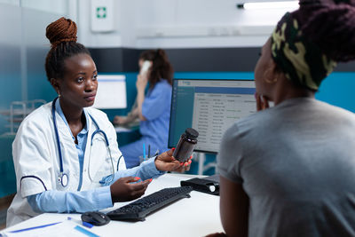 Doctor talking with patient at hospital