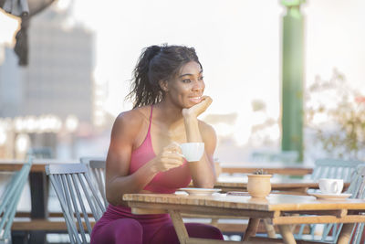 Woman sitting on table at cafe