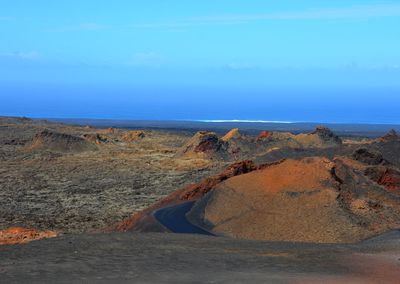 Scenic view of beach against blue sky