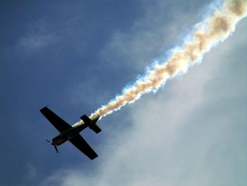 Low angle view of airplane against sky