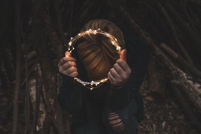 Full length of woman holding mask
