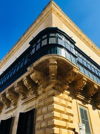 Low angle view of building against blue sky