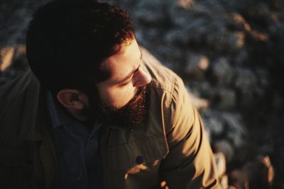 High angle view of bearded man looking away during sunset