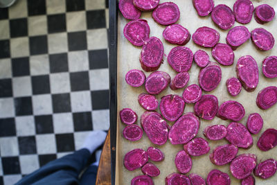 High angle view of hand with pink cake