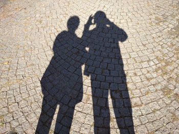 Shadow of man on footpath