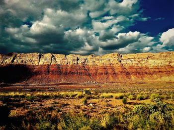 Low angle view of rock formations against cloudy sky