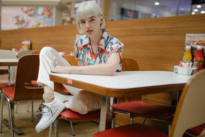 Full length of a girl sitting on table