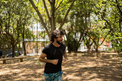 Man running and jogging at a park outdoors. male person workout. feel good, healthy concept. 