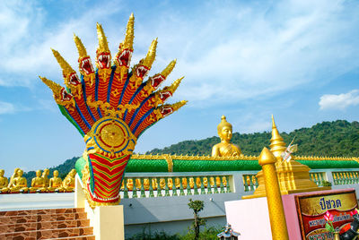 Sculpture of temple against building