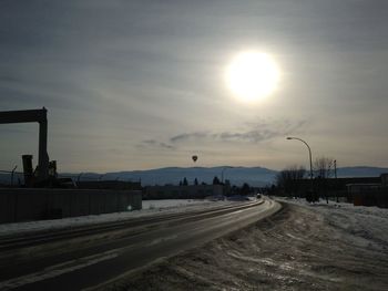 Street against sky during sunset