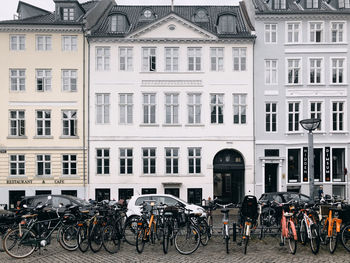 Bicycles on street against buildings in city