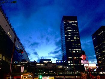 Low angle view of illuminated city against sky at night