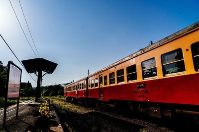 Train on railroad tracks against clear sky