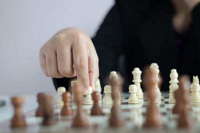 Low angle view of man playing on chess board