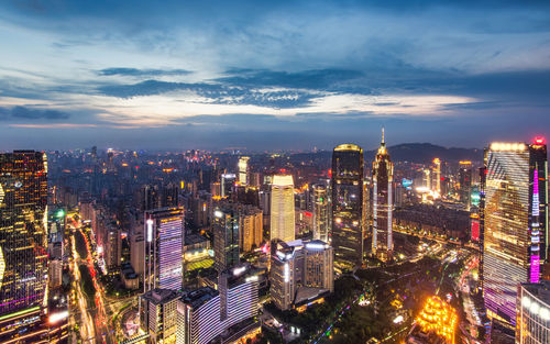 High angle view of illuminated city buildings against sky