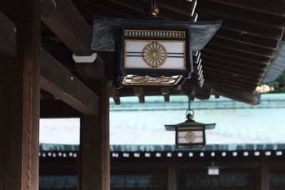 Low angle view of lanterns hanging from roof at meiji-jingu shrine