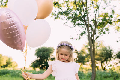 Portrait of girl holding balloons