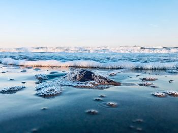 Scenic view of sea against clear sky during winter