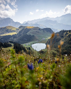 Scenic view of sea and mountains against sky