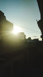 Silhouette buildings against sky during sunset