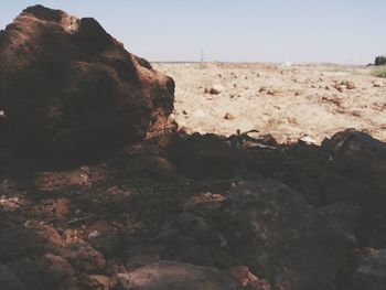 Scenic view of rocky beach against sky