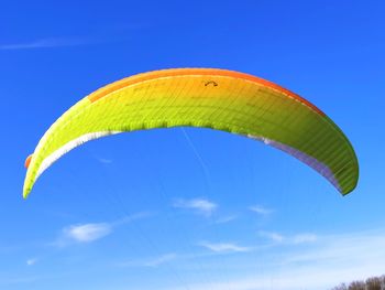 Low angle view of kite flying against blue sky